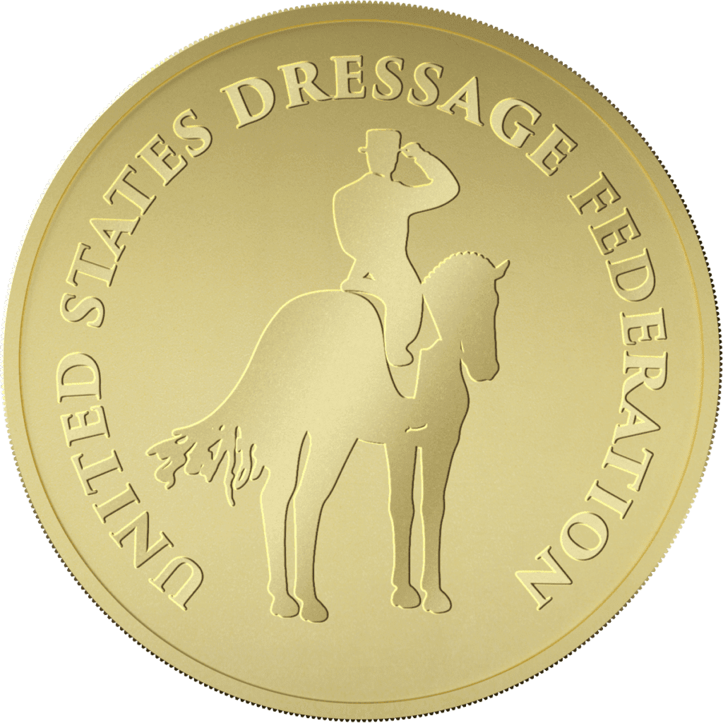 A gold coin features a rider on a horse in the center, with the text UNITED STATES DRESSAGE FEDERATION engraved around the edge.