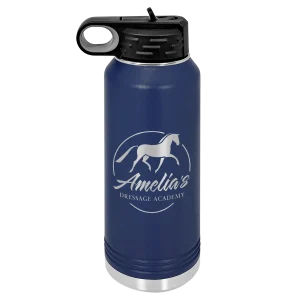 A blue 32 Oz water bottle with a flip-top lid, featuring a white horse logo and the words Amelias Dressage Academy on the front—perfect for staying hydrated at your next dressage event.
