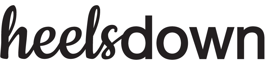 The word heelsdown is written in a bold, black, cursive and sans-serif mixed font on a light background, evoking the elegance of Dressage Training.