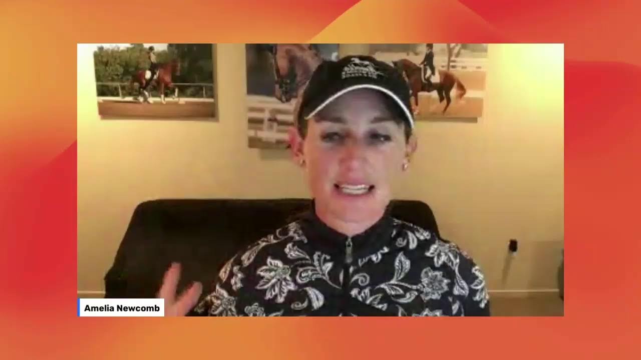 A woman in a patterned shirt and black cap speaks in front of a webcam, with horse photos on the wall behind her. A label in the corner reads Amelia Newcomb. The background features an orange gradient border.