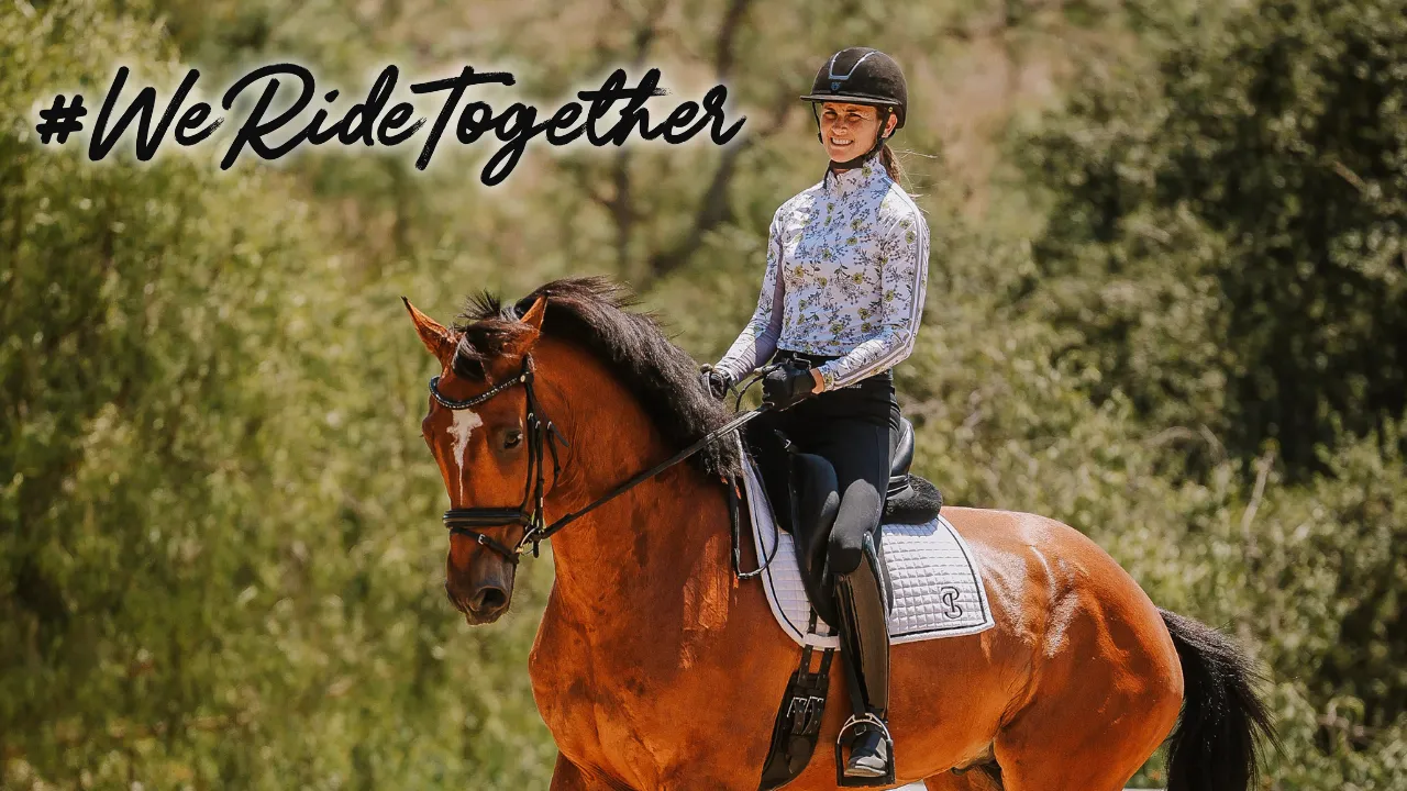 A person in riding gear smiles while riding a brown horse outdoors at Thunderbird Show Park. The background is green and leafy, with “#WeRideTogether” written in bold script in the top left corner, highlighting this exciting event.