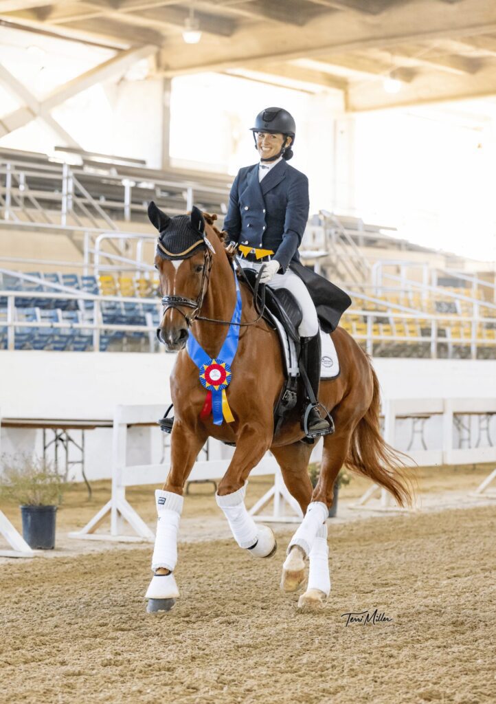 Amelia and her horse ride around with championship ribbons.