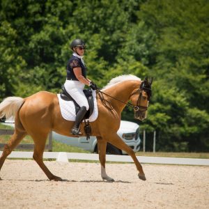 Online student Katie competing at a dressage competition.