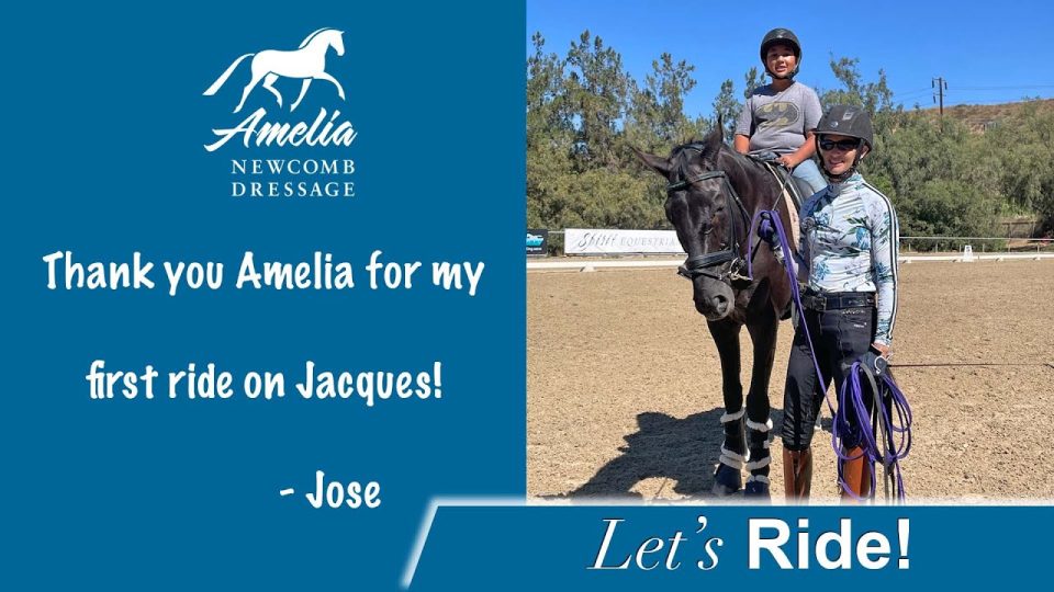 A smiling woman stands beside a black horse ridden by a child, both wearing helmets, on a sandy riding arena. Text thanks Amelia Newcomb Dressage for the ride on Jacques, signed by Jose.